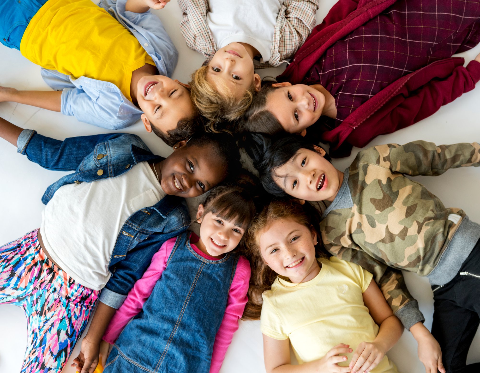 group-primary-schoolers-lying-ground-smiling